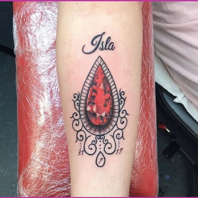Little Tattoos — Ruby birthstone tattoo on the left inner arm....